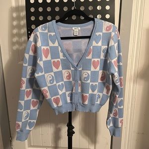 Checkered blue and white sweater with pink designs